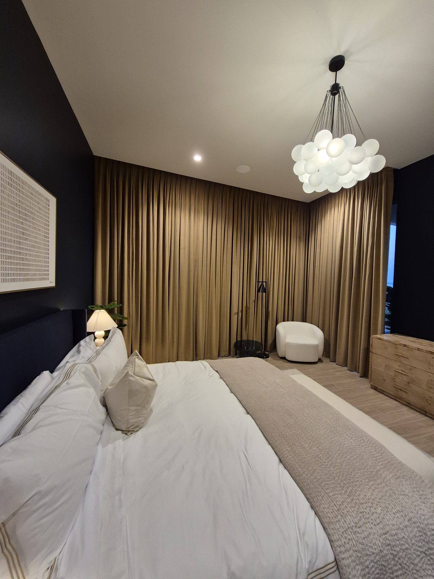 Motorized floor-to-ceiling drapes in a South Florida bedroom
