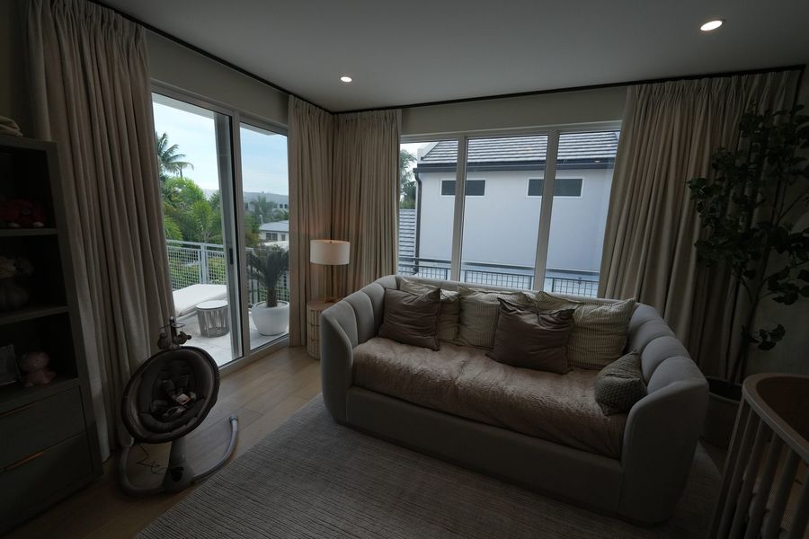 Ceiling-mounted ripplefold draperies open to the pool, Fort Lauderdale