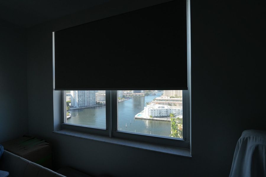 Blackout roller shade on a bedroom window facing the marina, Hallandale Beach
