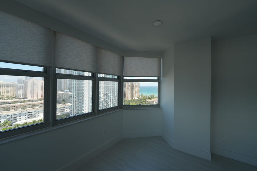 Roller shades on city-facing windows of a Hallandale Beach condo