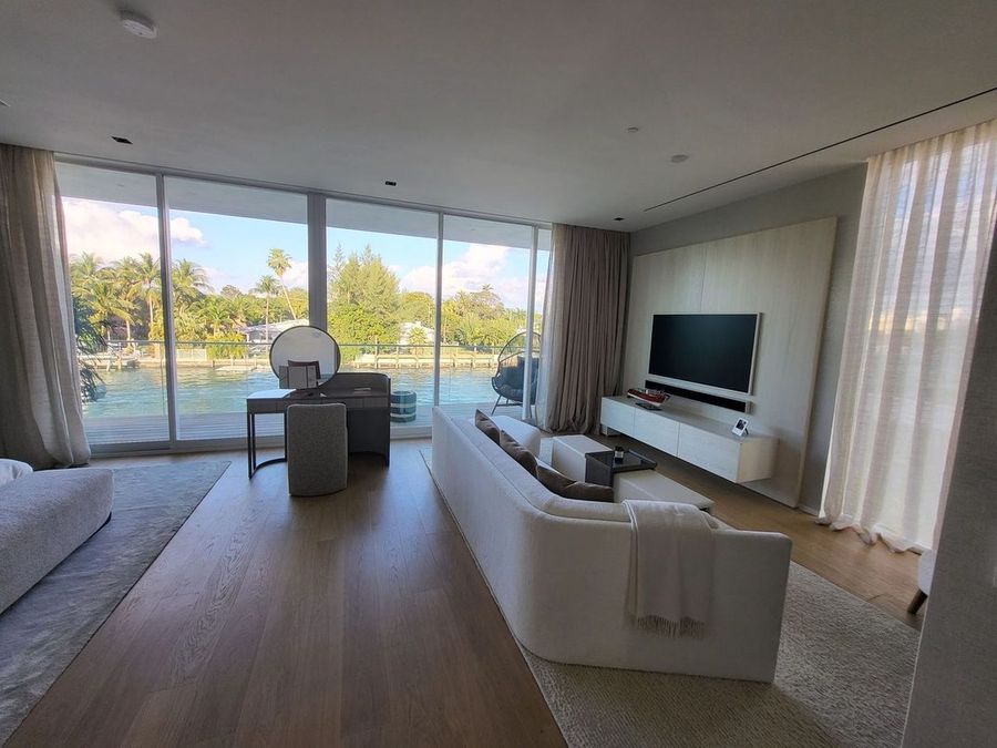 Living room with motorized sheer draperies and a water view, Ritz-Carlton Residences Miami Beach