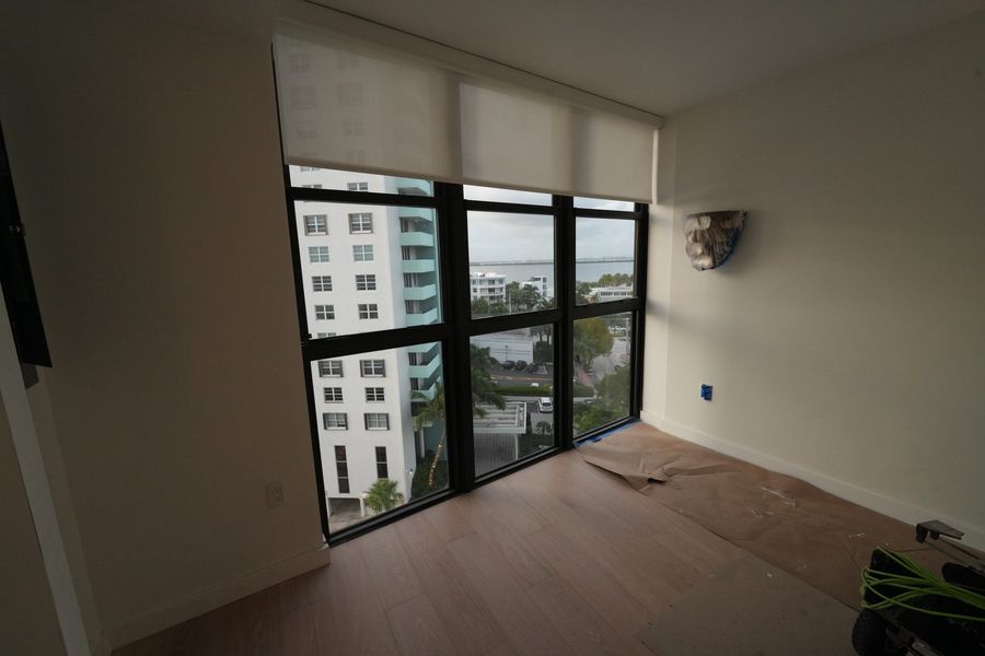 Light-filtering roller shade on a bedroom window, South Beach, Miami Beach