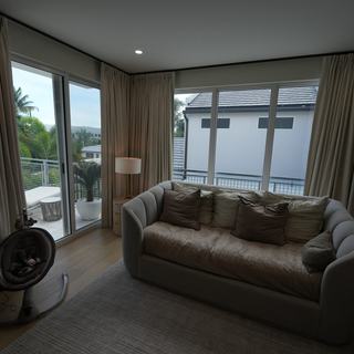 Ceiling-mounted ripplefold draperies open to the pool, Fort Lauderdale