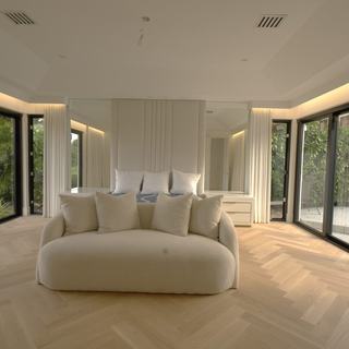 Master bedroom with Kravet Smart ripplefold drapery stacked open under a custom wood valance, glass walls to the garden, Boca Raton