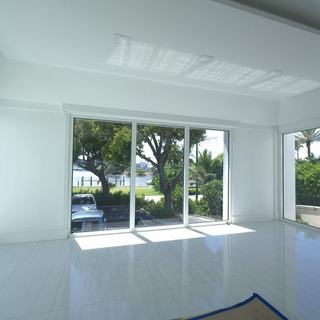 Street-side room with motorized shades pocketed above the glass, Hillsboro Beach