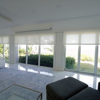 Basketweave 90 Bright White solar shades across the oceanfront living room glass on Hillsboro Mile