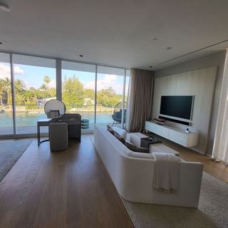 Living room with motorized sheer draperies and a water view, Ritz-Carlton Residences Miami Beach