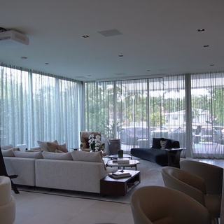 Ripplefold sheers drawn across a full wall of glass over the water, Ritz-Carlton Residences Miami Beach