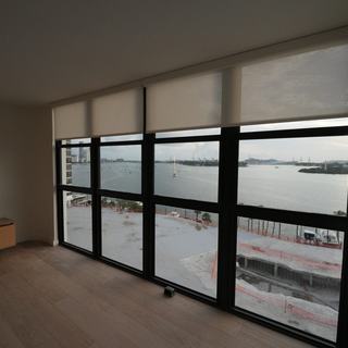 View of Biscayne Bay through light-filtering roller shades, South Beach condo, Miami Beach