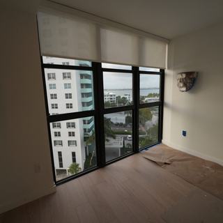 Light-filtering roller shade on a bedroom window, South Beach, Miami Beach