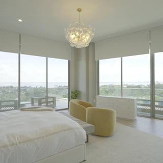 Primary bedroom with chandelier, motorized roller shades and Décor de Paris Luna Sheer drapery, St. Regis Longboat Key