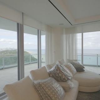 Highland blackout shade rolling up off corner glass to the bay view, Ritz-Carlton Residences Sunny Isles Beach