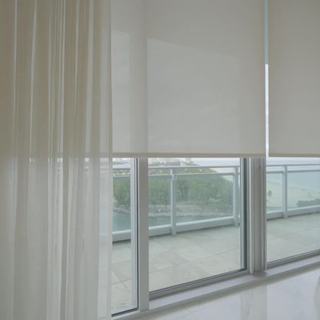 T-Screen 3% solar shade layered behind sheer draperies in a Sunny Isles Beach residence
