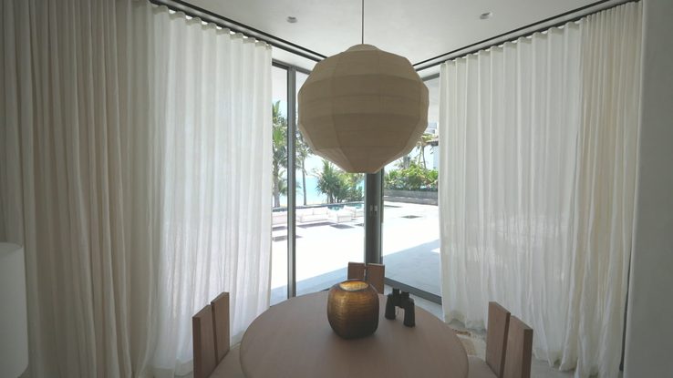 Sheer ripplefold draperies on customized decorative Lutron track