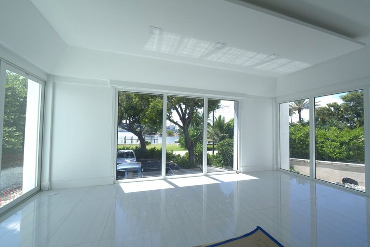 Street-side room with motorized shades pocketed above the glass