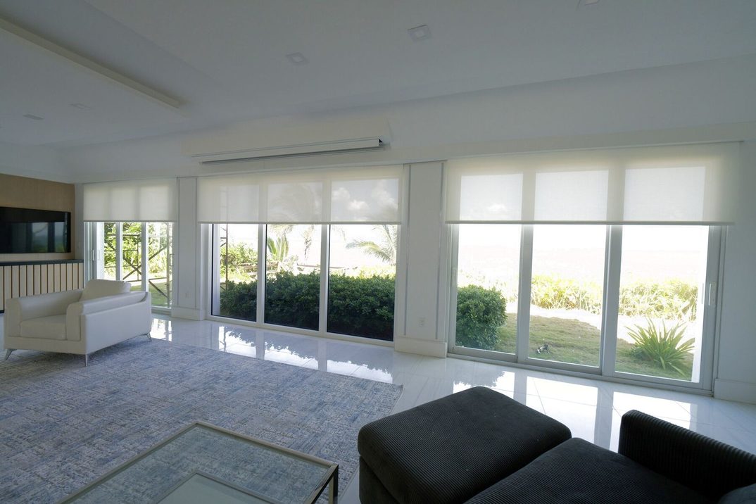 Basketweave 90 Bright White solar shades across the oceanfront living room glass on Hillsboro Mile