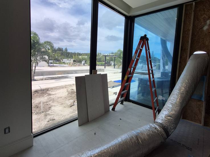 Ductwork, lumber and a ladder in front of the glass on measuring day