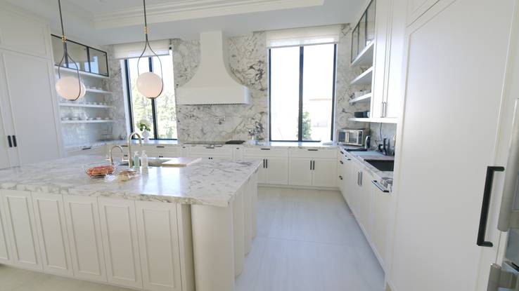 Kitchen with the fixed faux-Roman valances that conceal the motorized rollers over the windows