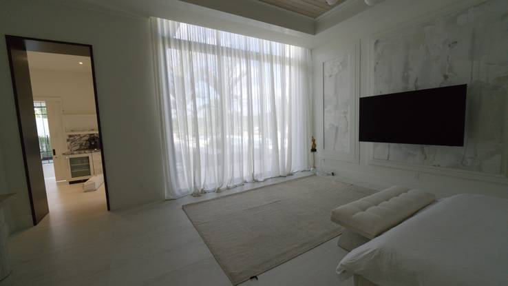 Primary bedroom with the Kravet Couture drapery drawn across the whole wall of glass