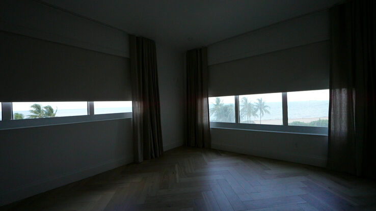 Second bedroom with the Berlin Snow White blackout rollers halfway down in their side channels over the ocean