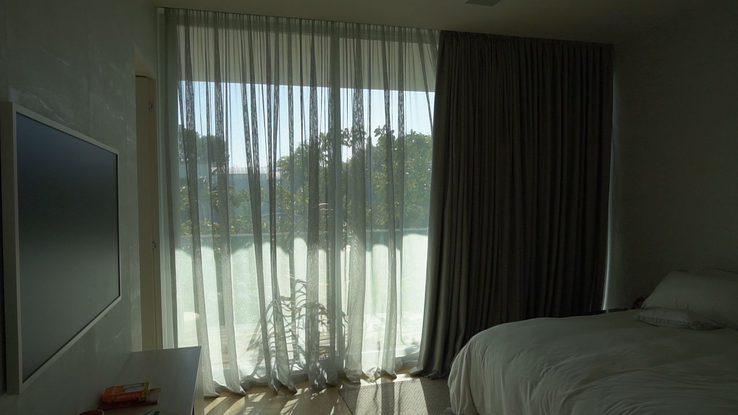 Bedroom with the sheer layer closed and the blackout layer open