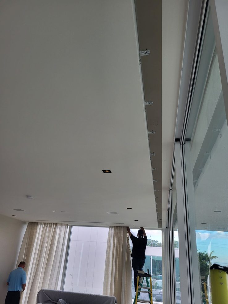 Ceiling drapery pocket during installation with the sheer layer being fitted