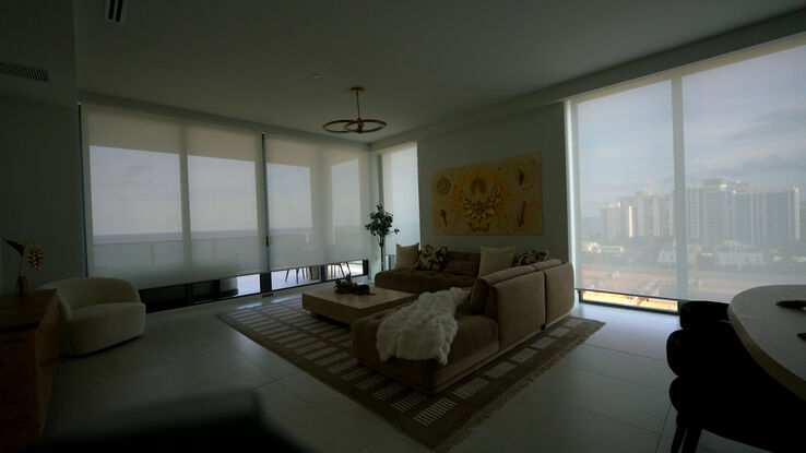 Living room at Salato, Pompano Beach with the E Screen 5% shades down and the ocean still visible through them