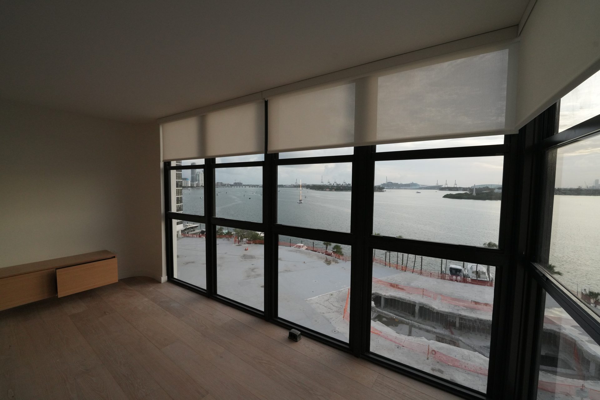 View of Biscayne Bay through light-filtering roller shades, South Beach condo, Miami Beach
