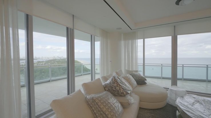 Highland blackout shade rolling up off the corner glass to the bay view