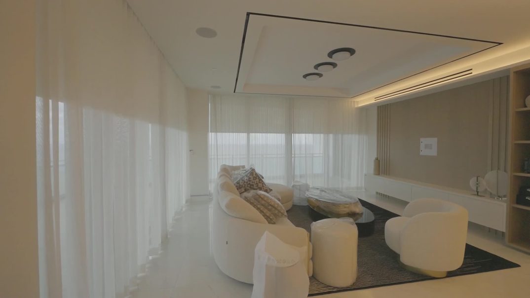Loro Piana Interiors Limoges White ripplefold sheers across the great room glass at the Ritz-Carlton Residences Sunny Isles
