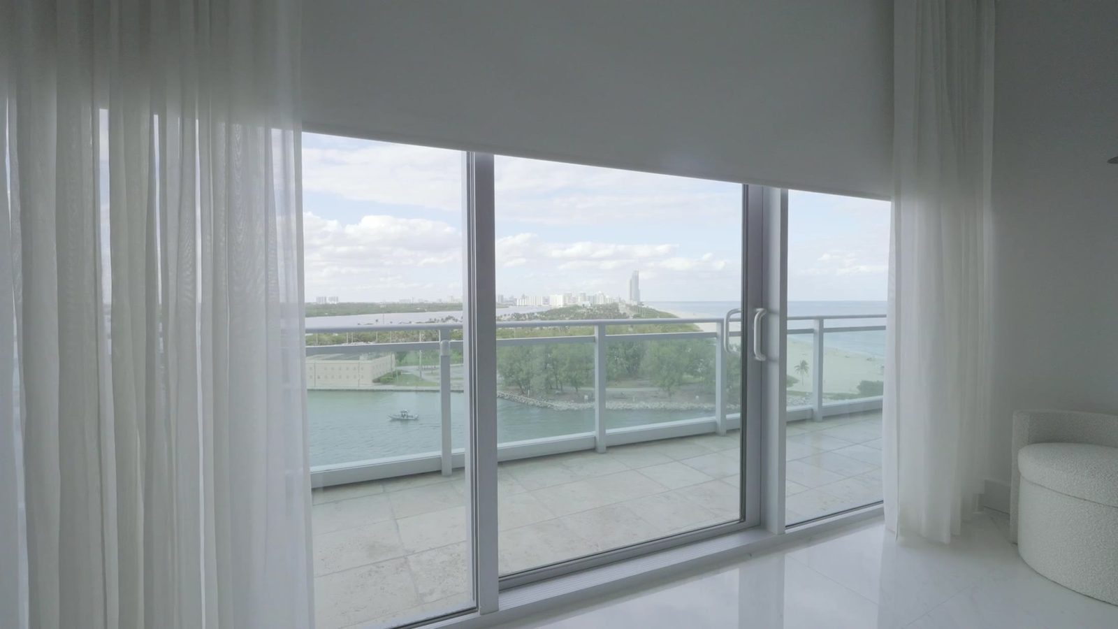 Terrace and water view through the open glass wall