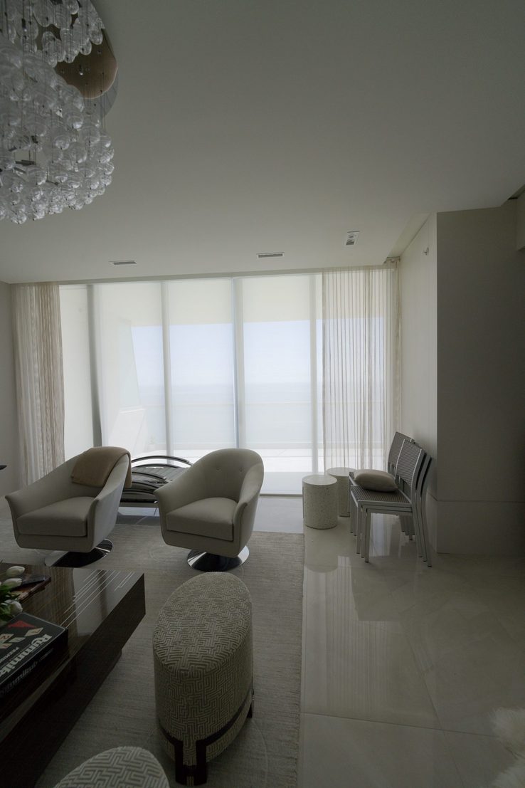 Living room solar shades and sheer drapery over the balcony at Turnberry Ocean Club
