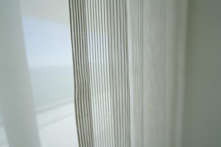 Romo Zyla Porcelain semi-sheer close up showing the textured weave at the glass